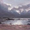 Two people on beach with storm clouds behind them