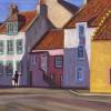 Lady walking past coloured houses in sun and shadows